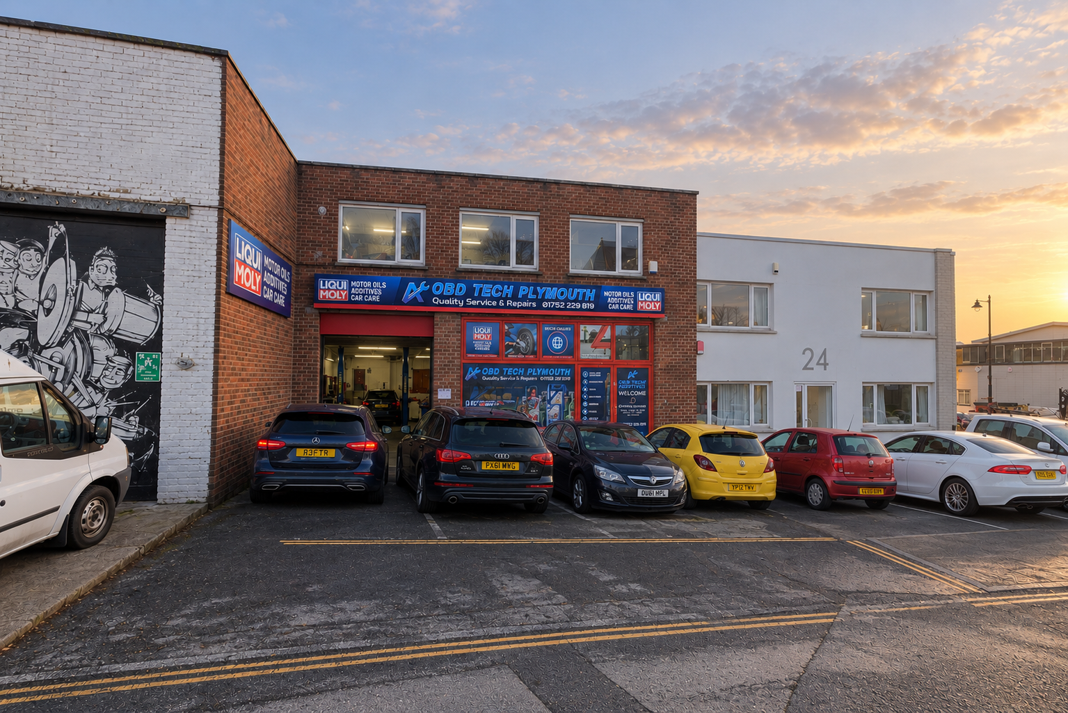 OBD Tech Plymouth garage exterior at dawn with cars parked outside